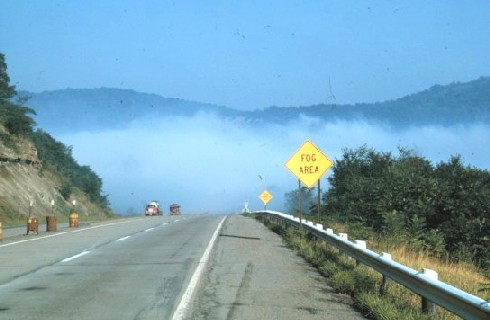 Valley fog with roadsign